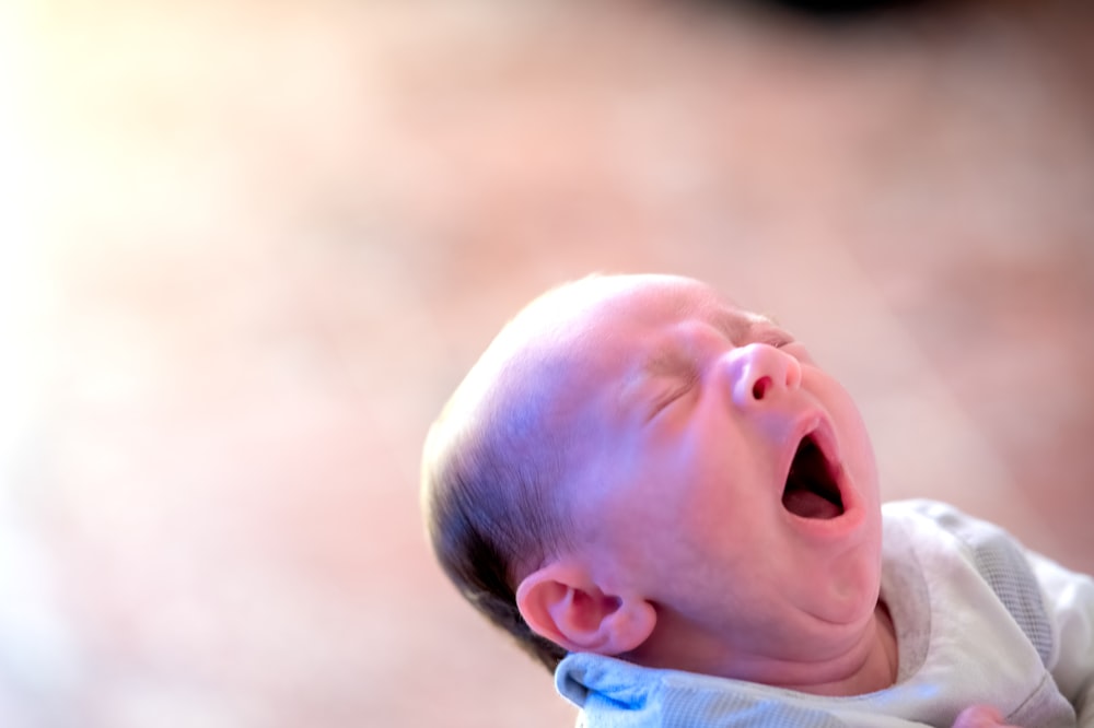 baby in blue and white shirt