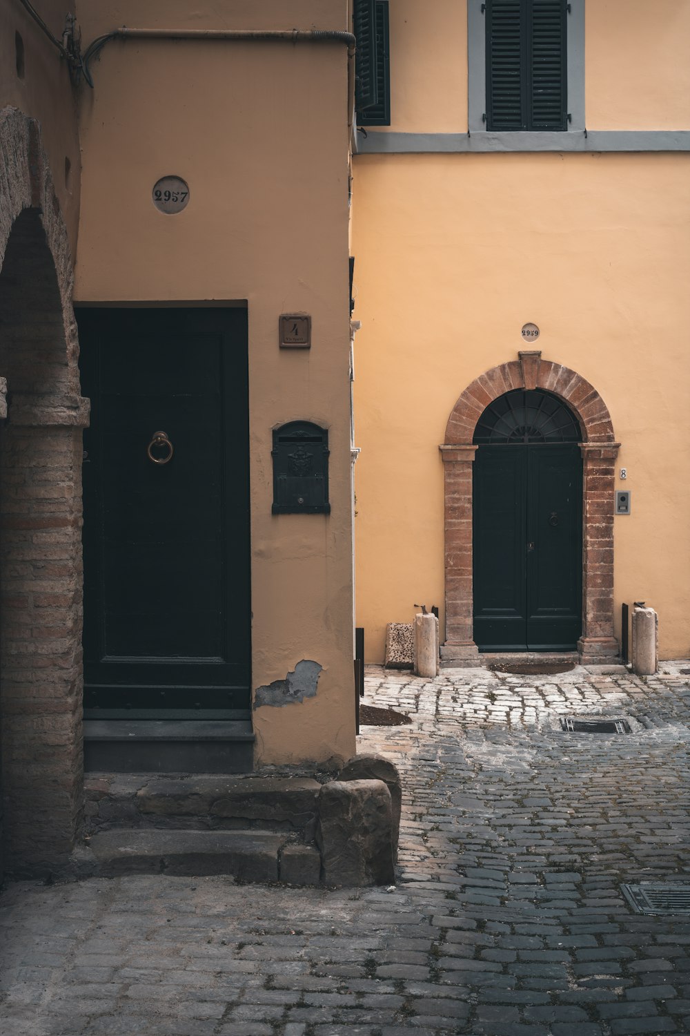 brown wooden door on yellow concrete building