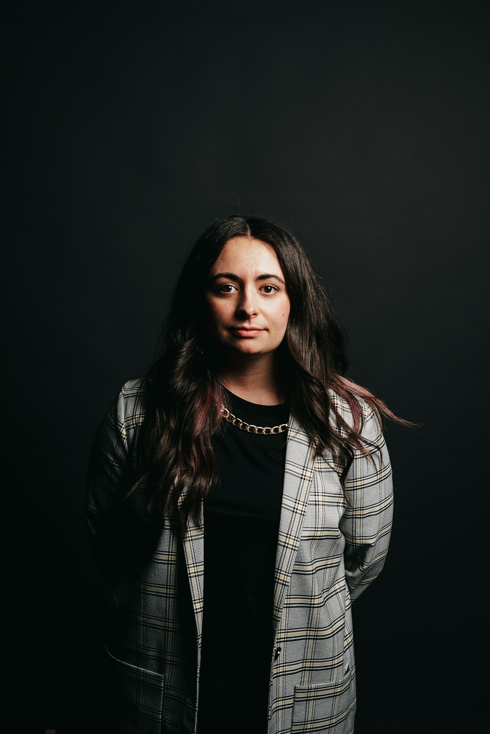 woman in black and white plaid blazer