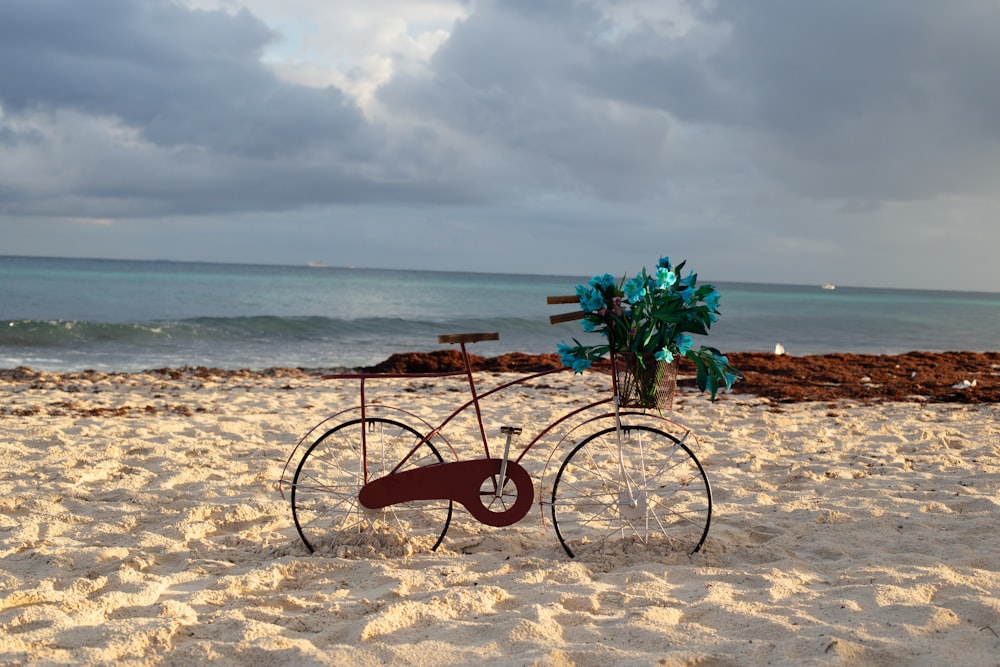 bicicletta marrone sulla sabbia marrone vicino allo specchio d'acqua durante il giorno
