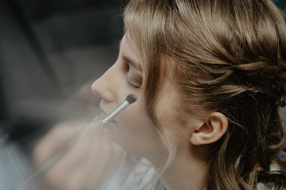 woman in white shirt with white cigarette stick