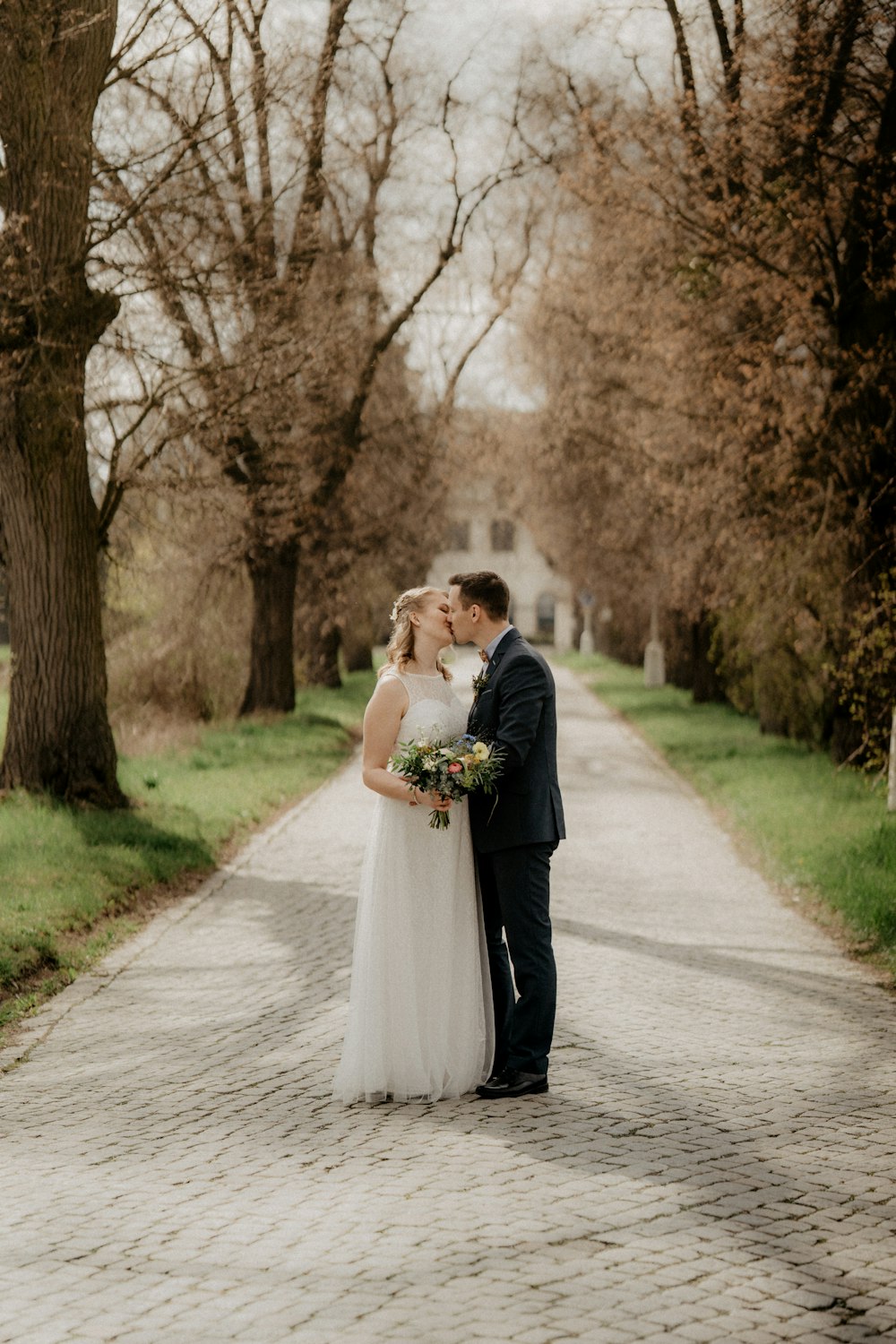 man and woman kissing on road during daytime