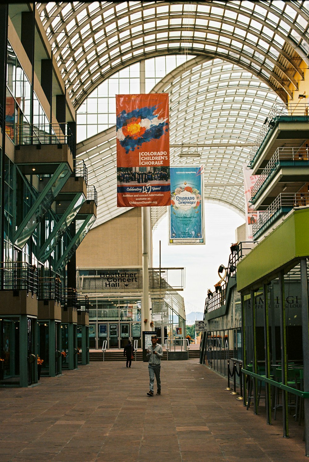 people walking on sidewalk near building during daytime