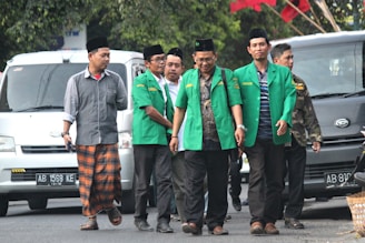 A group of men in casual outfits laughing together on a city street.