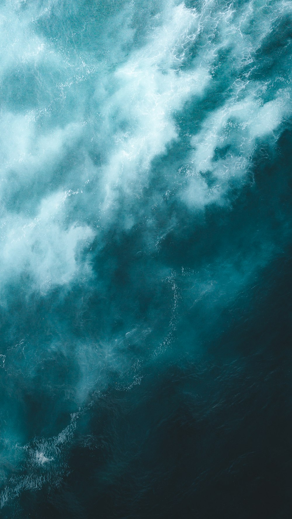 white and blue clouds over body of water