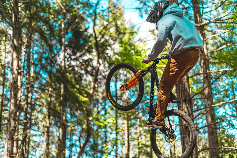 man in gray jacket riding on bicycle