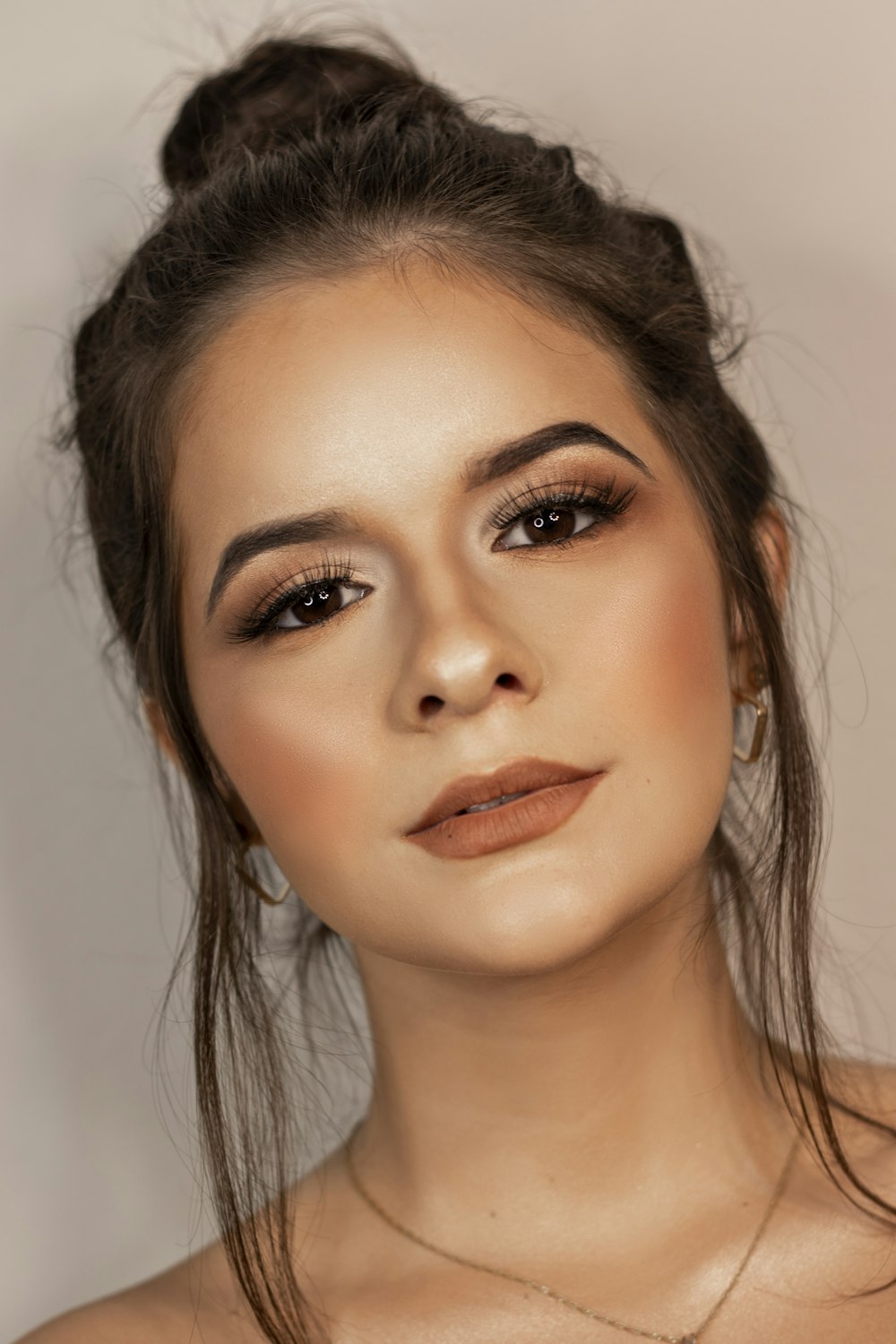 woman with brown hair and pink lipstick