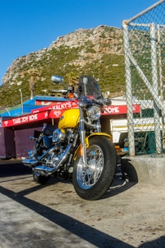 A shiny red Hero motorcycle parked outside Yenning Motors shop in Kakching.