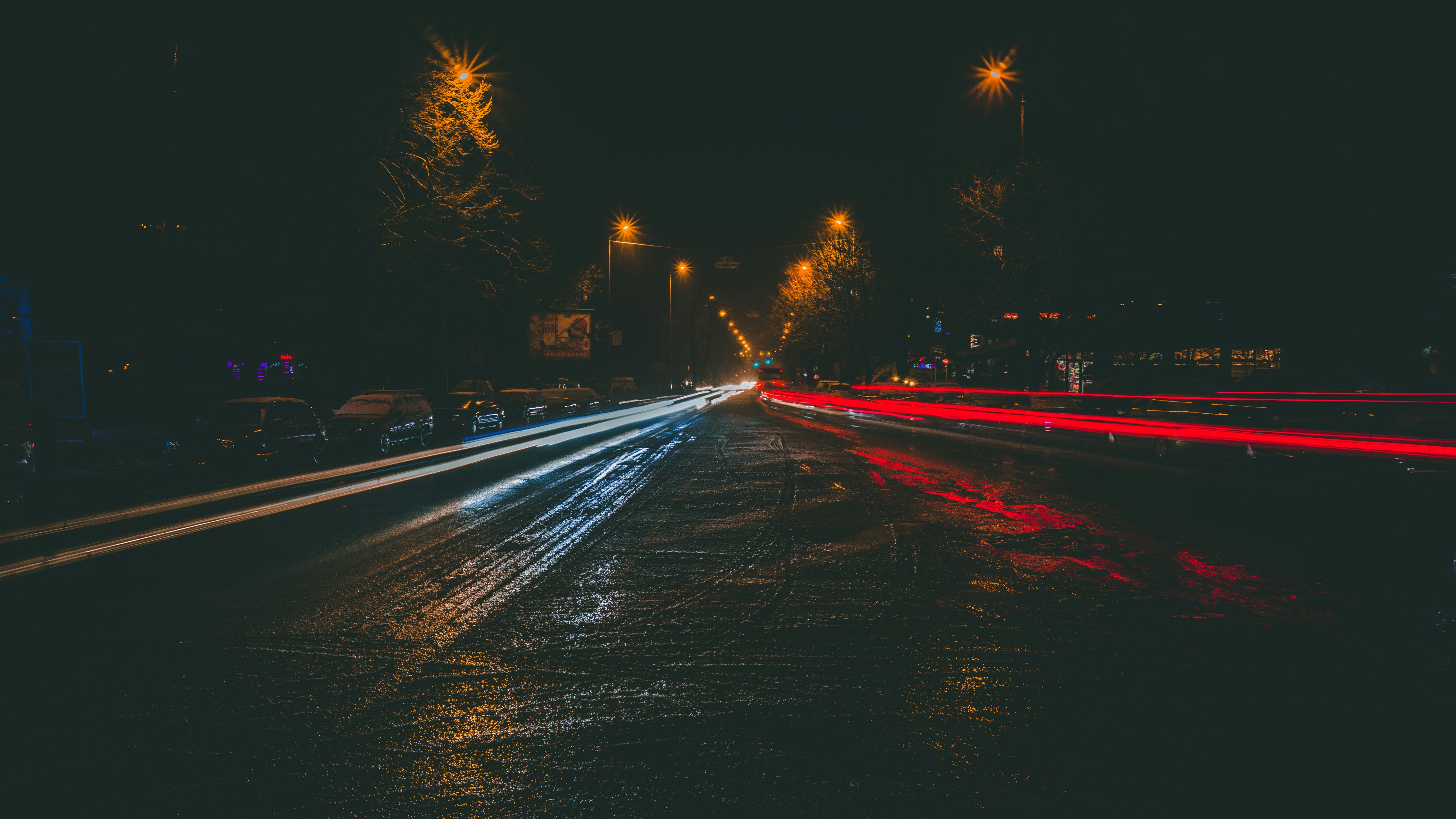 Security patrol vehicle at night on empty road, headlights cutting through darkness, moody atmospheric night scene