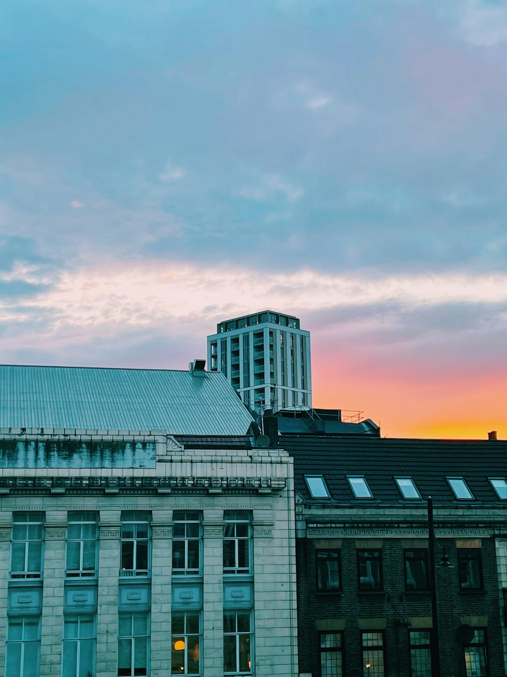 white and brown concrete building under white clouds during daytime