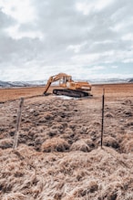 brown car on brown field under white clouds during daytime