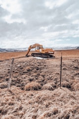 brown car on brown field under white clouds during daytime