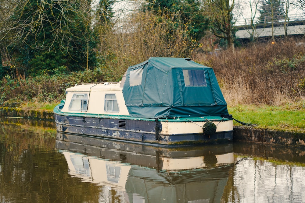 white and blue boat on river during daytime