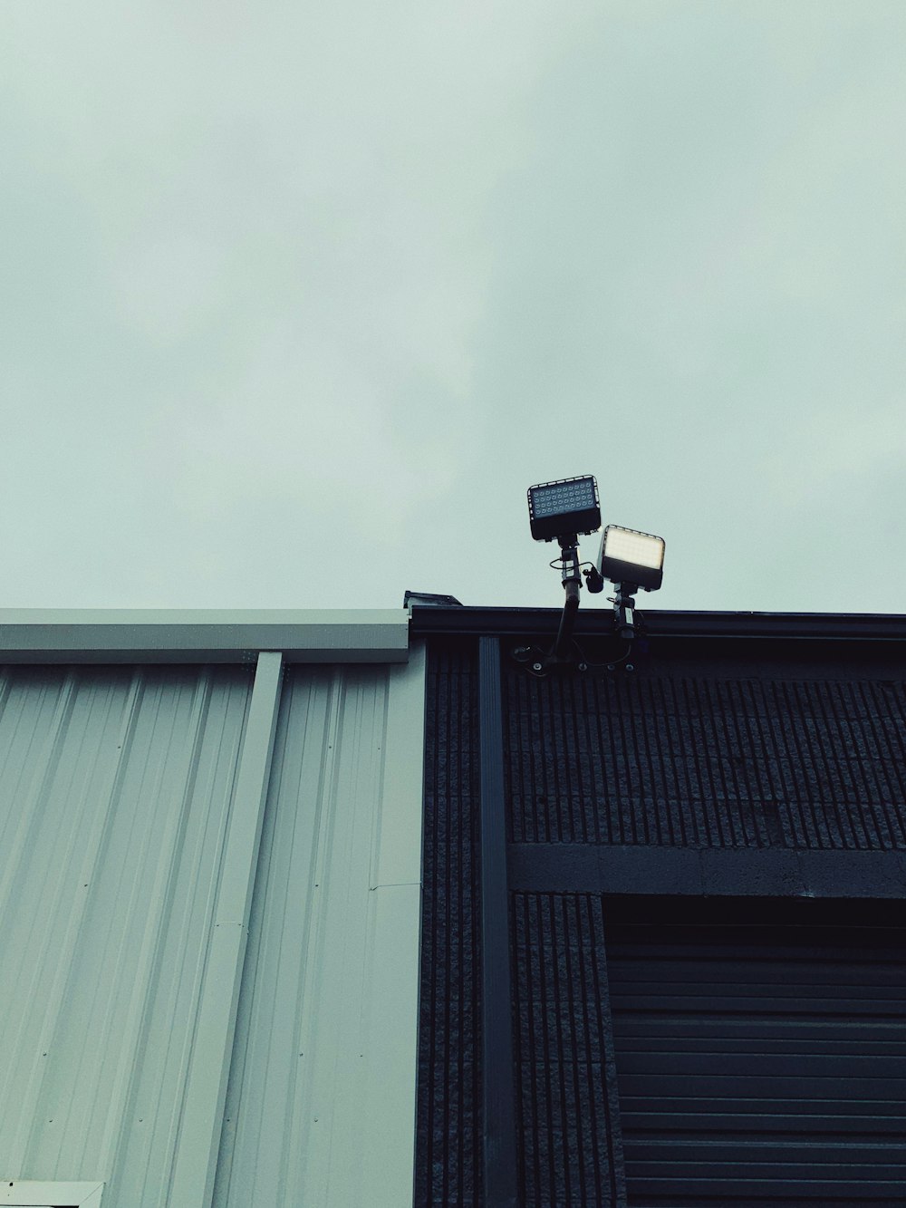 a camera on top of a building with a sky background