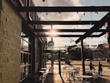 black metal chairs and tables near brown brick building during daytime