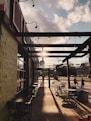 black metal chairs and tables near brown brick building during daytime