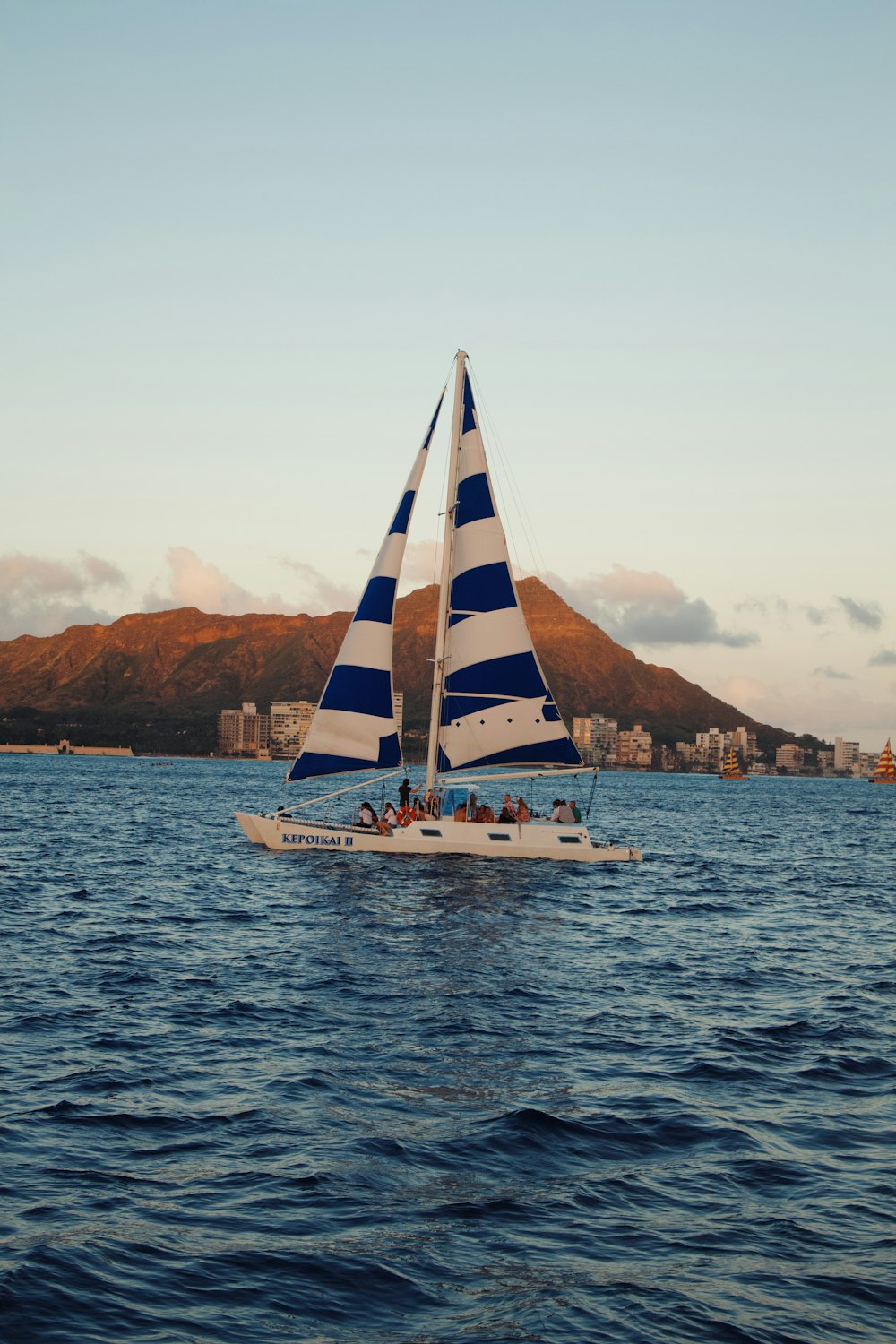 white and blue sailboat on sea during daytime