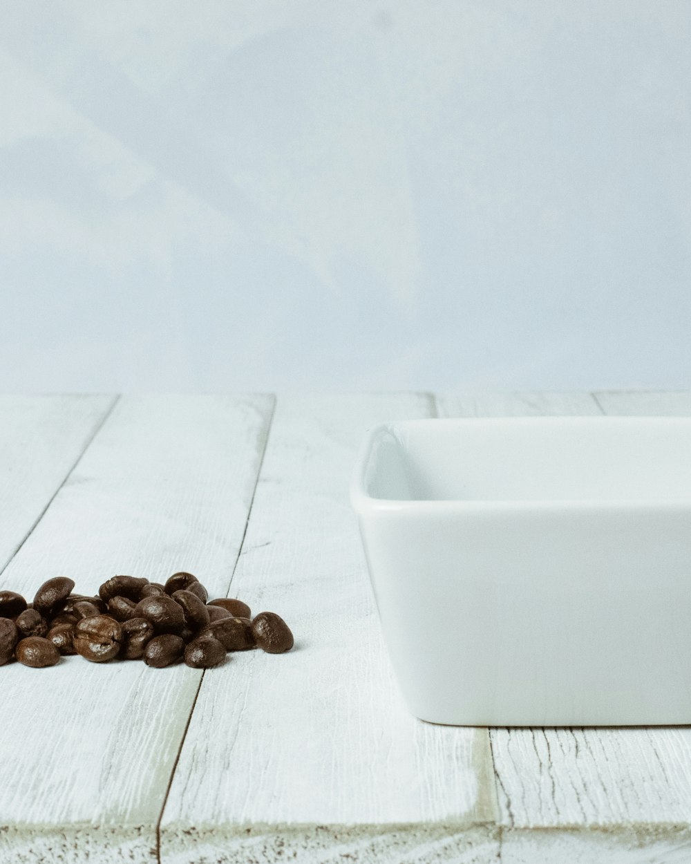 brown coffee beans on white plastic container