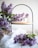 Elegant handcrafted decorative piece with soft lilac tones displayed on a wooden shelf.