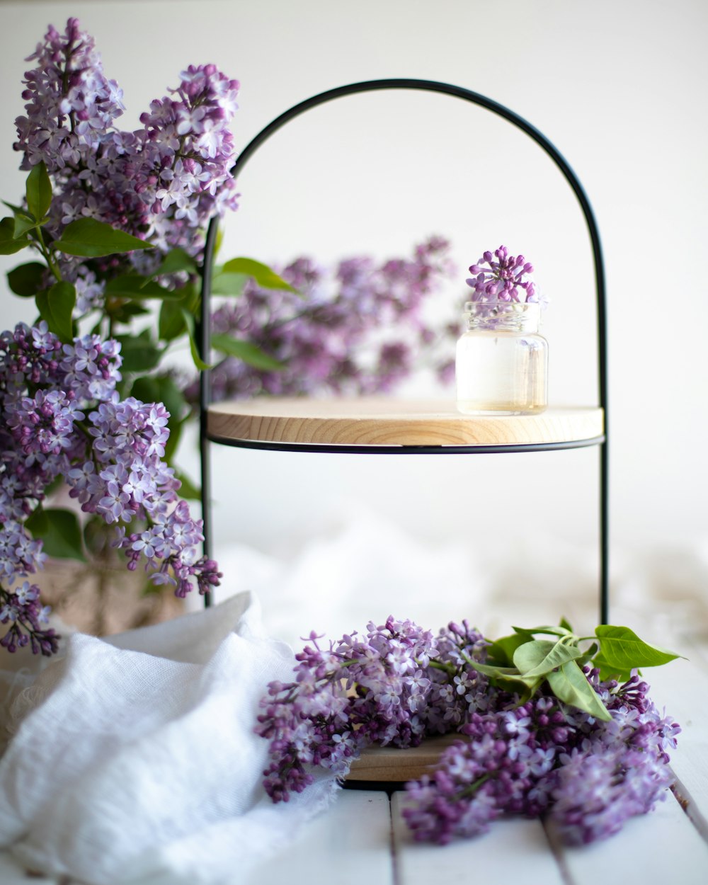 purple flowers on brown wooden round table