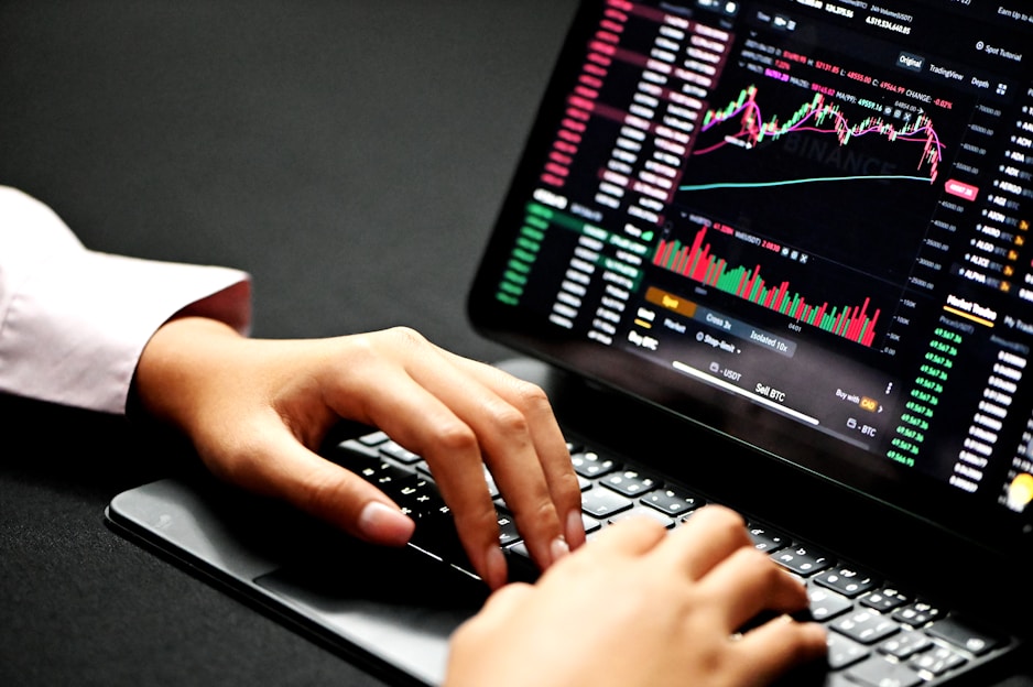 Person working on laptop with digital marketing charts on screen