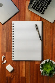 black pen on white notebook