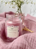 A bright spring-themed candle with floral designs.