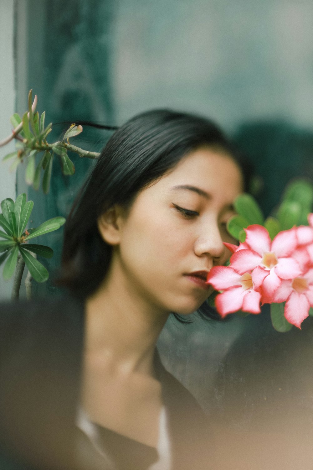 woman in pink lipstick holding pink flower