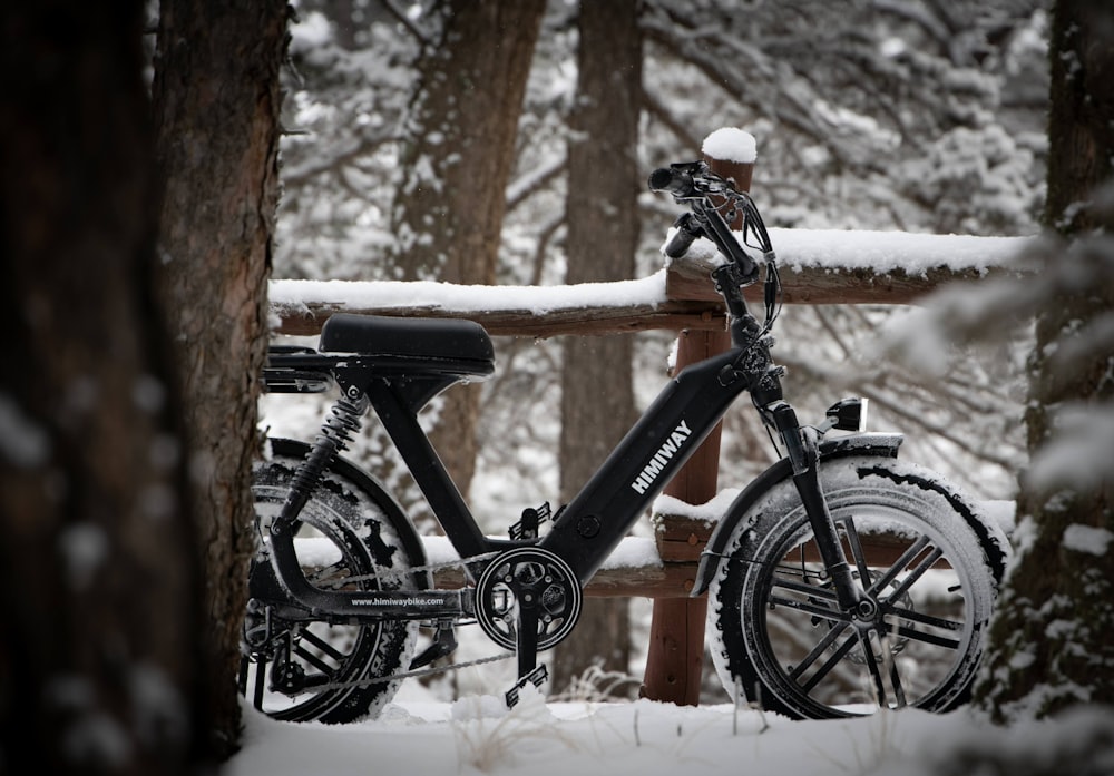 black and orange hardtail mountain bike on snow covered ground