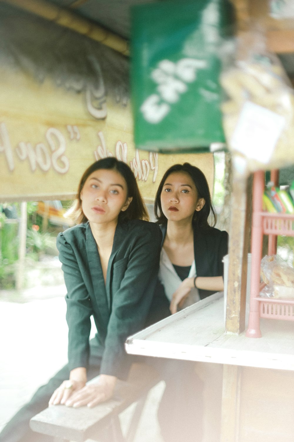 2 women standing beside white table