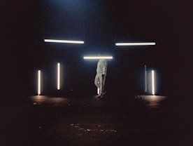 man in white shirt standing on brown ground