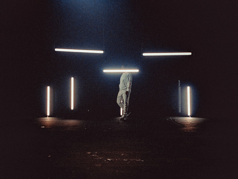 man in white shirt standing on brown ground