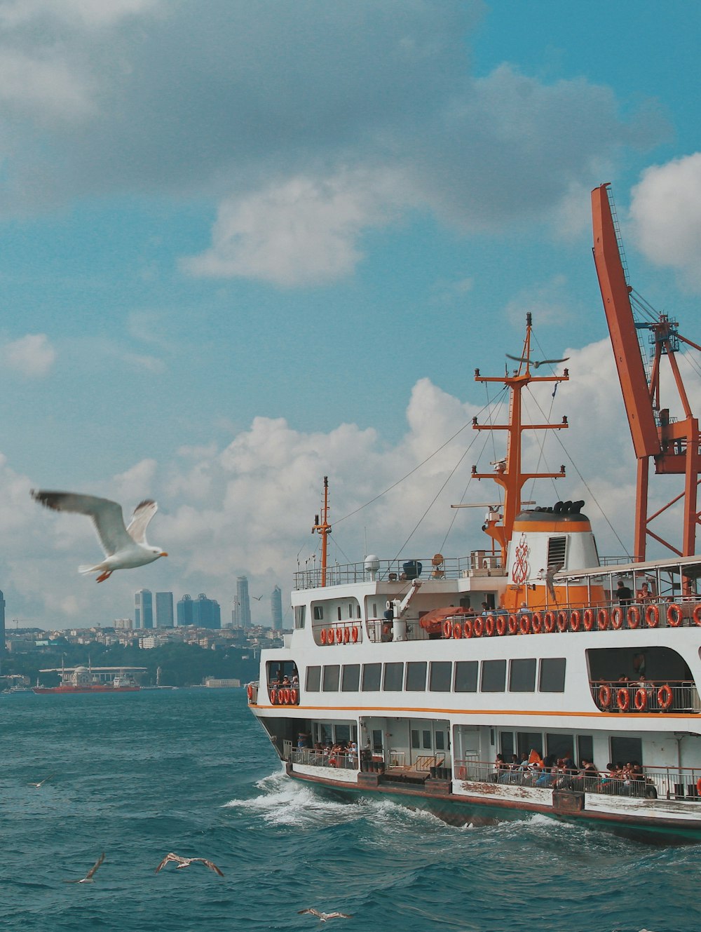 white and red ship on sea under blue sky during daytime