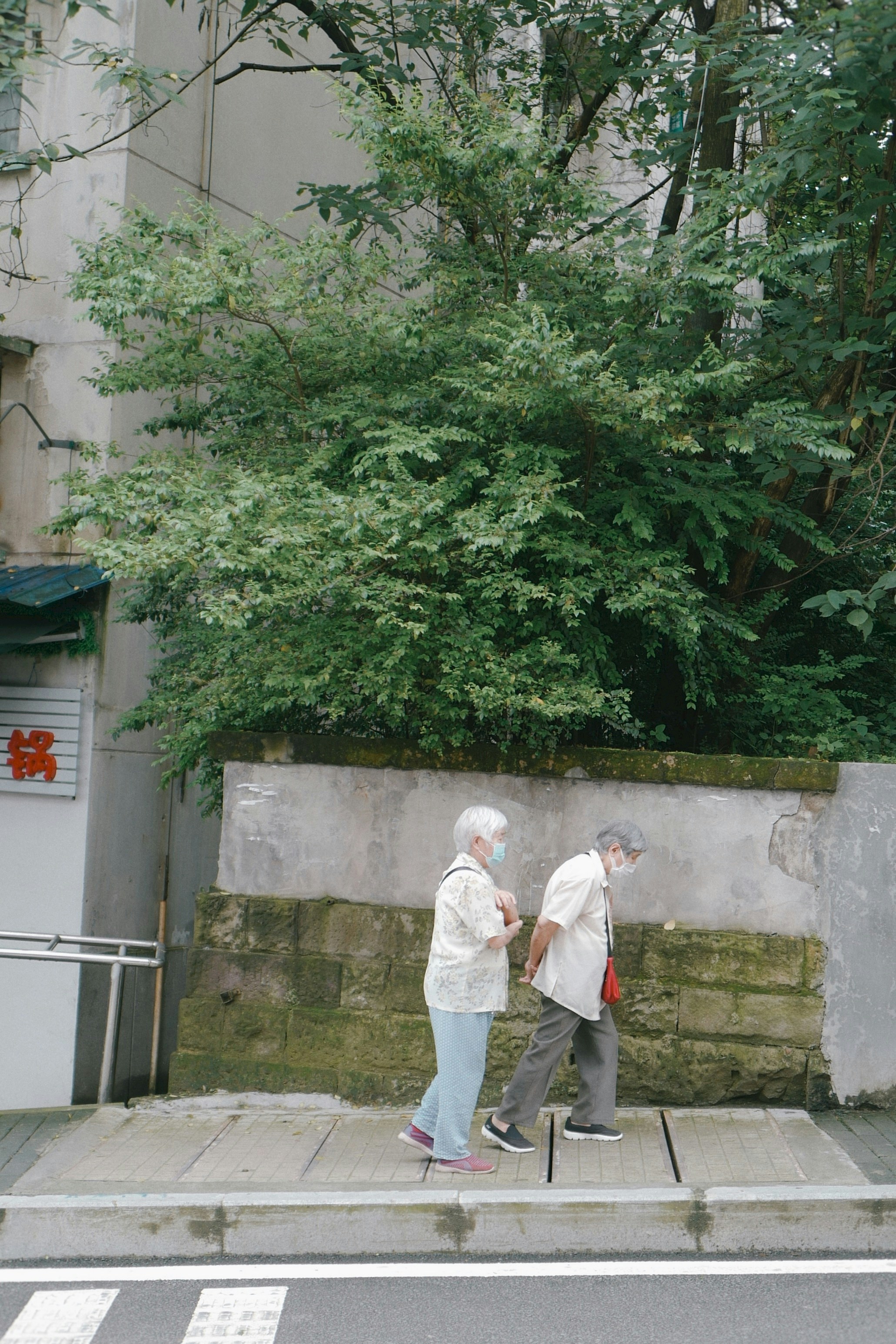 man in white thobe standing near green trees during daytime