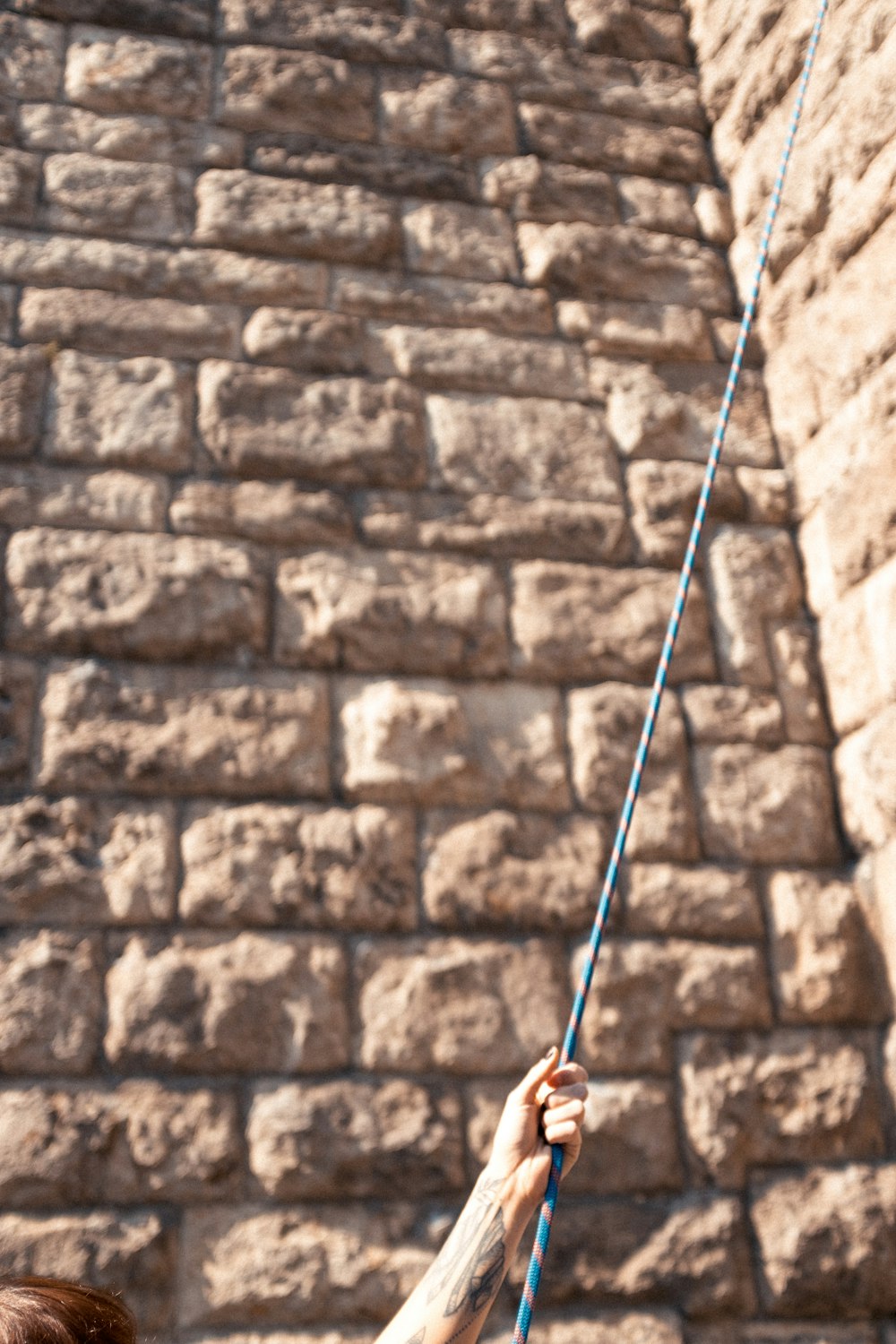 brown rope on brown brick wall