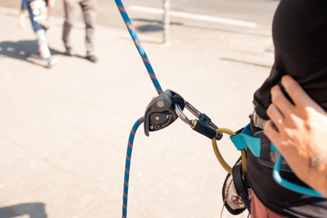 person in black jacket with blue sling bag