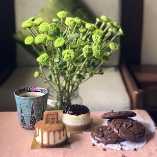 A cozy floral arrangement with cupcakes displayed elegantly on a wooden table.