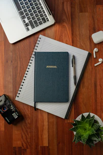 black spring notebook on brown wooden table