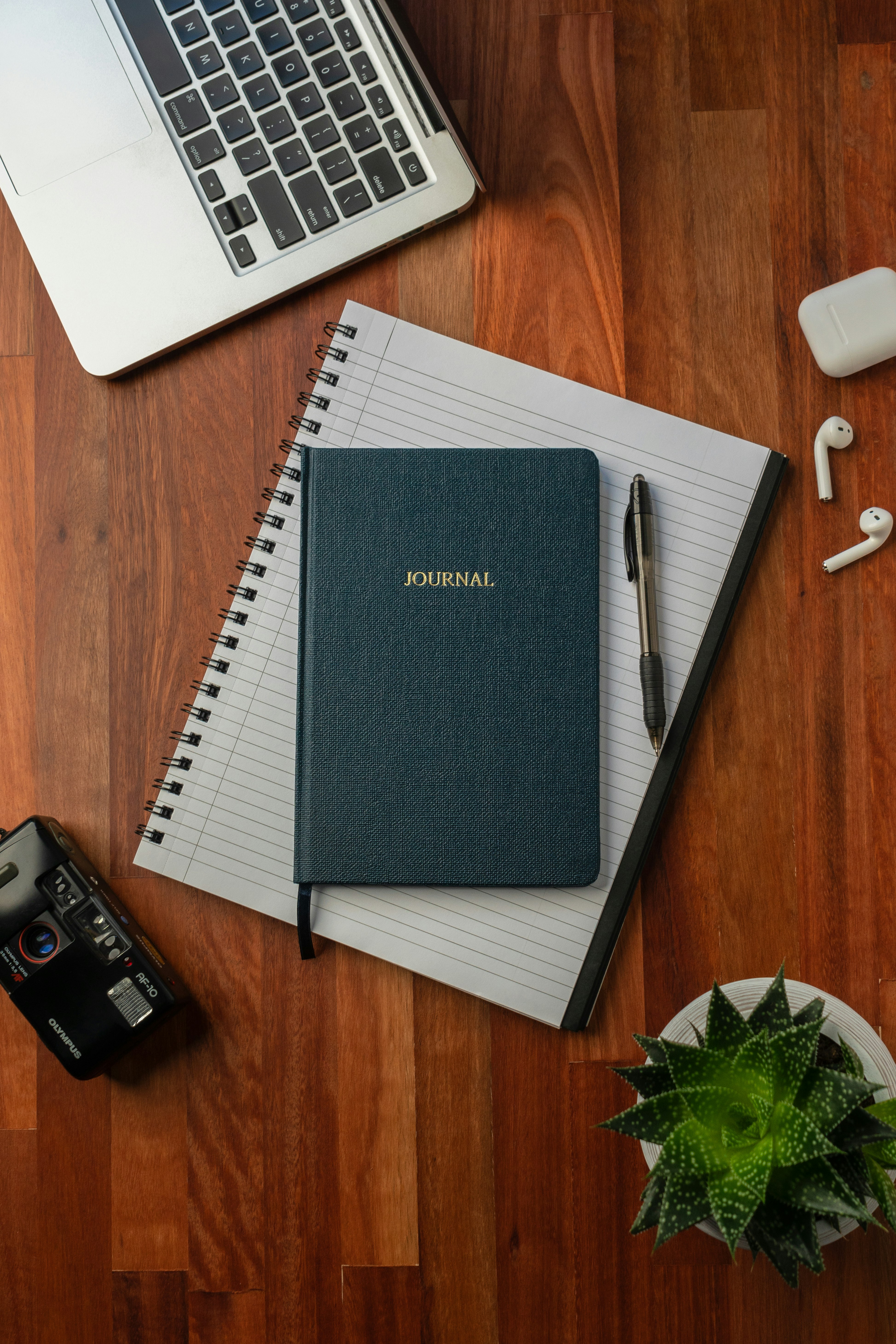 black spring notebook on brown wooden table