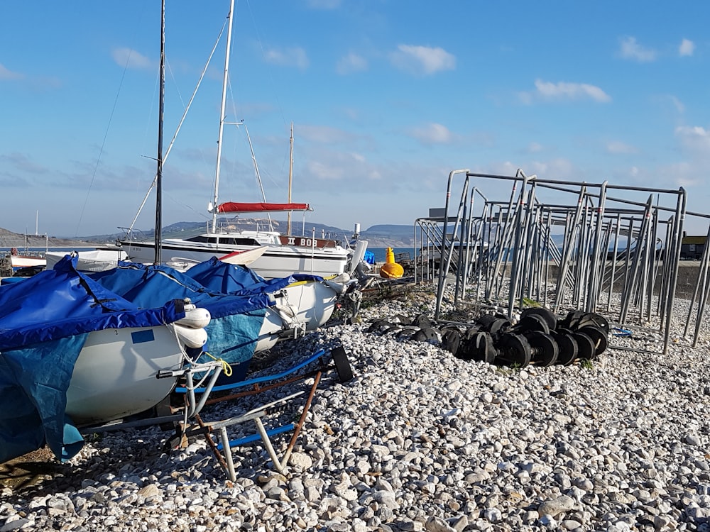 white and blue boat on sea shore during daytime