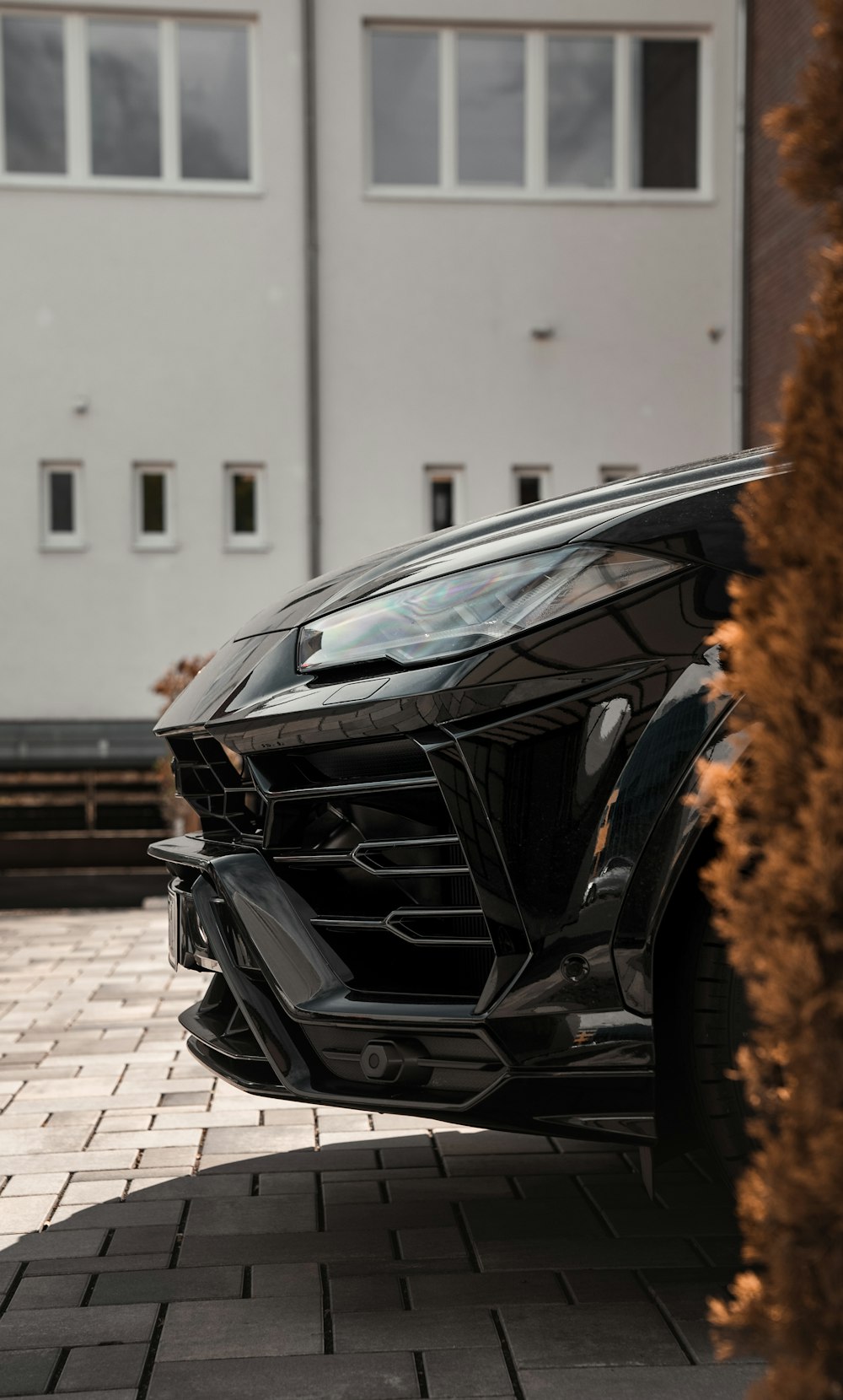 black car parked near white building