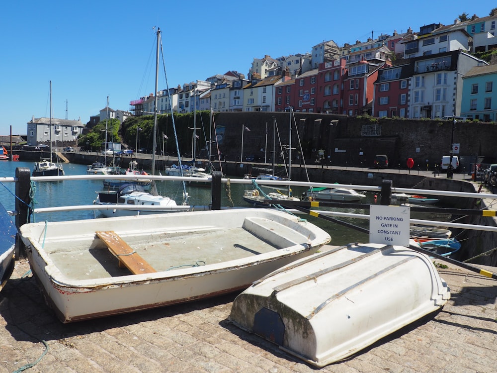 white boat on dock during daytime