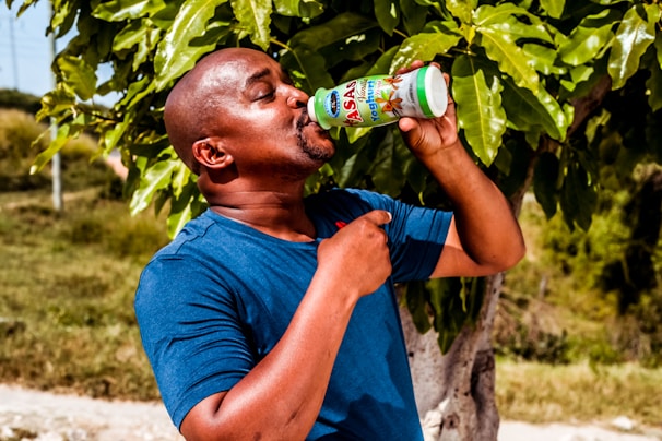 Lifestyle shot of a person enjoying an nctr drink outdoors on a sunny day.