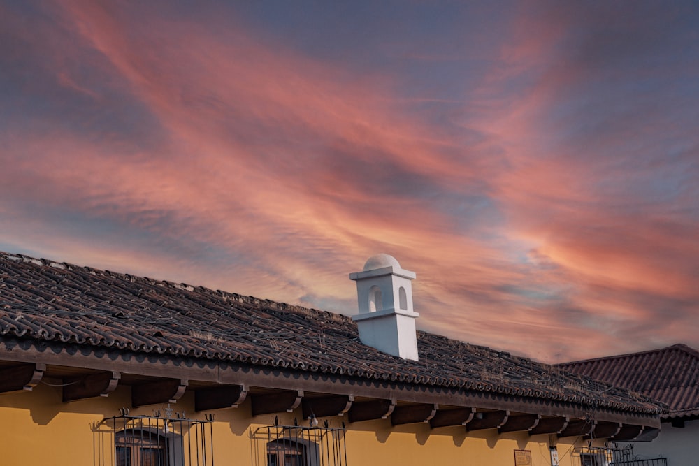 white and brown concrete house under orange and blue sky