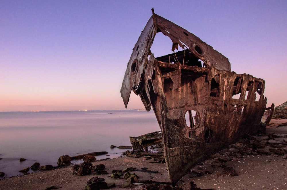 brown wooden ship on sea shore during daytime