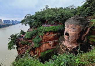 A vibrant photo of travelers enjoying a scenic view of Bamyan’s cliffs and Buddha statues.