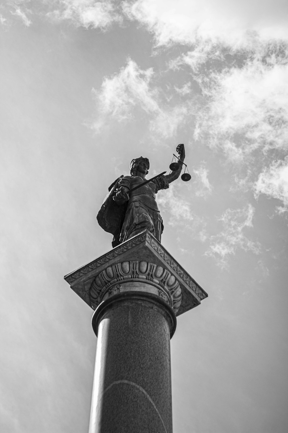 grayscale photo of man riding horse statue