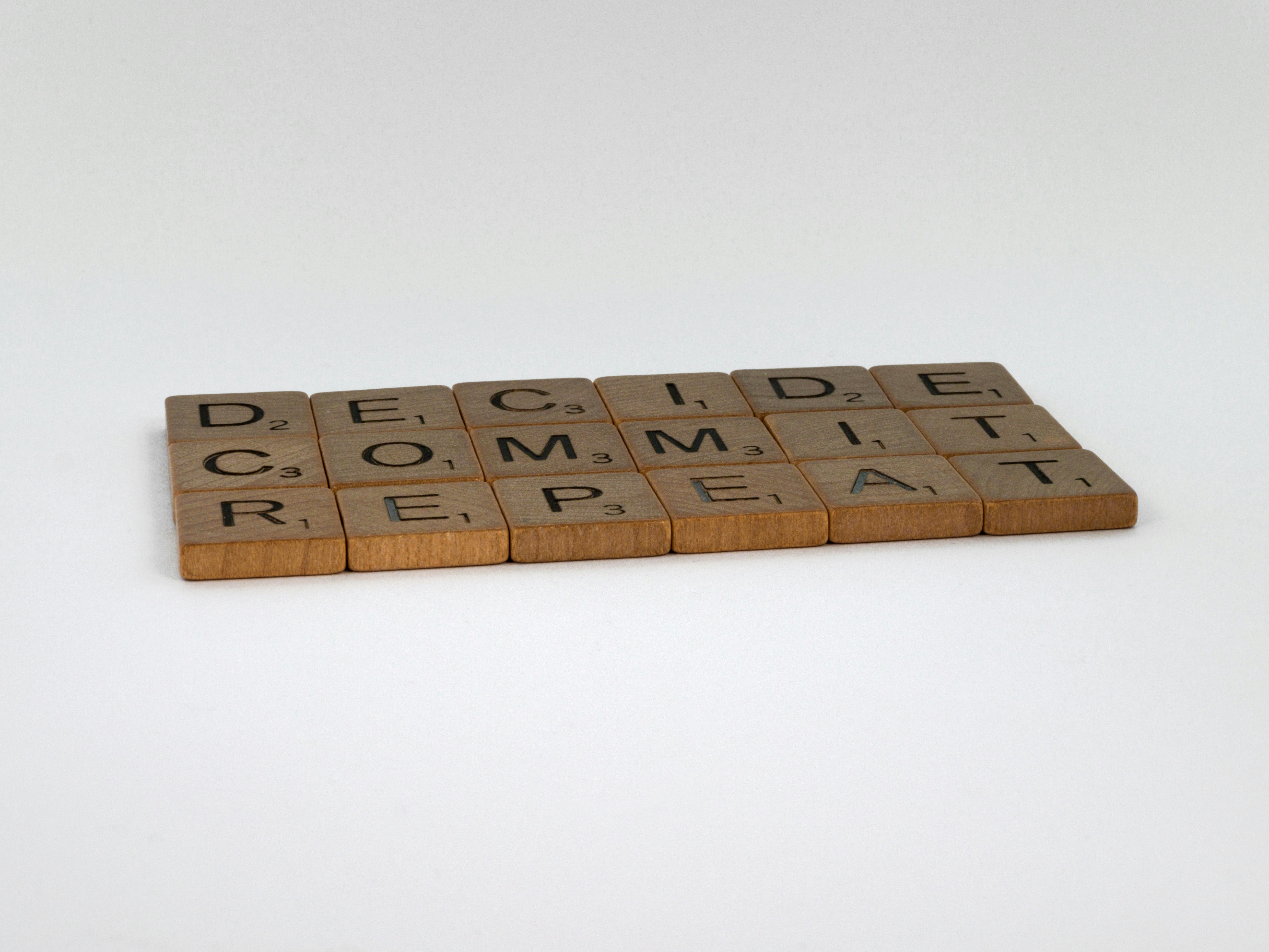 scrabble, scrabble pieces, lettering, letters, wood, scrabble tiles, white background, words, quote, letters, type, typography, design, layout, focus, bokeh, blur, photography, images, image, decide commit repeat, discipline, relentless, training, decisions, action, plan, dream, life, real life, progress, make progress, mindfulness, seize the day, carpe diem, live live, live life to the full, 
