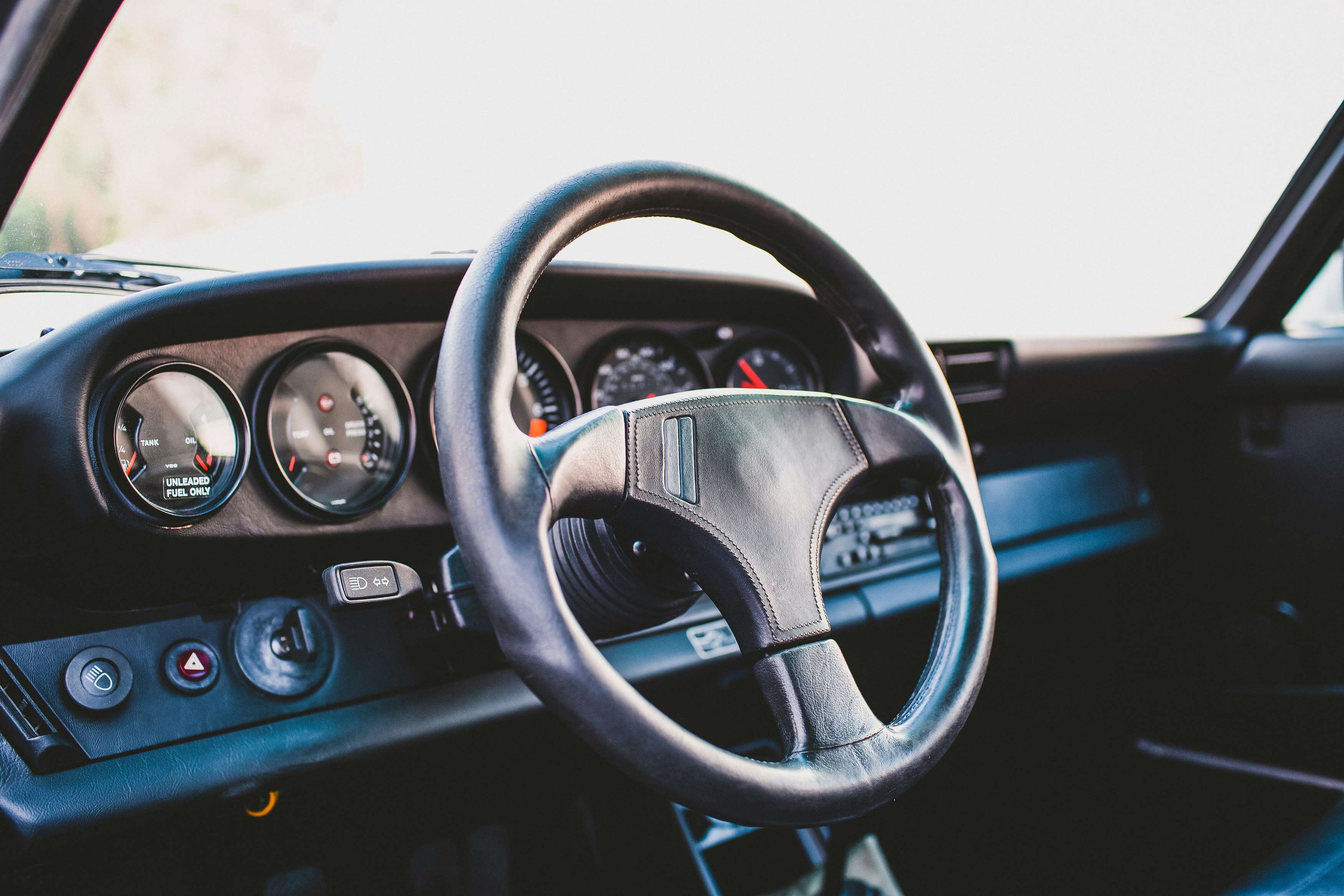 black car steering wheel during daytime