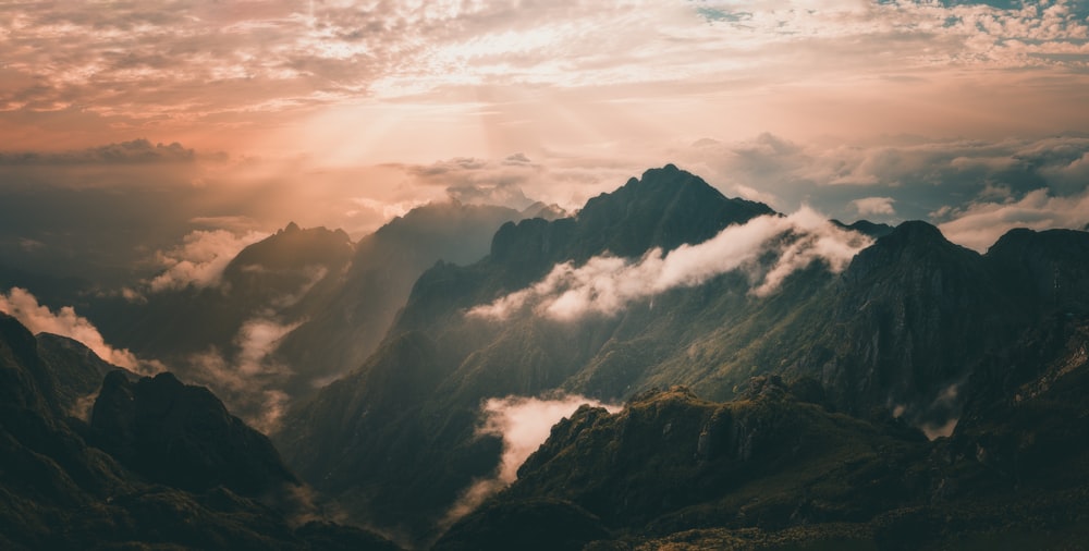 black and white mountains under white clouds